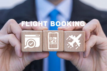 Businessman holding wooden blocks and sees inscription: FLIGHT BOOKING. Concept of flight booking. Airline ticket booking.