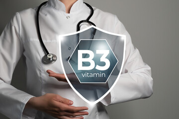 Molecular model of vitamin B3, Niacin. Shield in doctor`s hands with Vitamin B3.