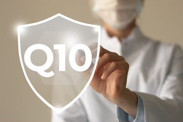  Microelement supplement concept. Shield in doctor`s hands with Q10 icon.