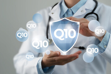  Microelement supplement concept. Shield in doctor`s hands with Q10 icon.