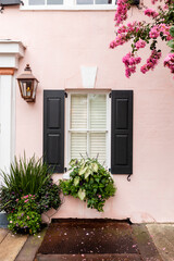 Old pink house with window box flowers Charleston