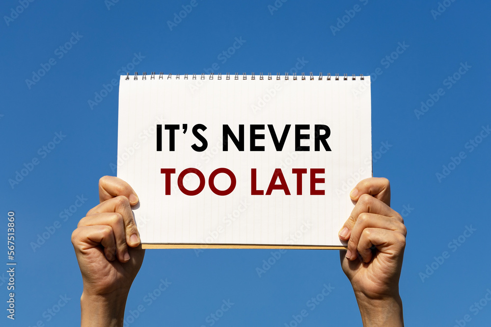 Poster it's never too late message on a notebook paper held by 2 hands with blue sky background. this text 