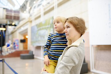 Little boy and his grandmother looking an exposition in a scientific museum. Child is interested in chemistry. Education and entertainment for children. Activities for family with kids.