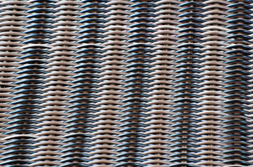 close-up on the back of a wicker chair, braided background, optical illusion