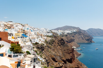 Fototapeta na wymiar Santorini houses on hill coastline overlooking ocean