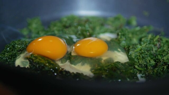 Fried egg with spinach in a frying pan 