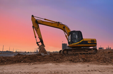 Fototapeta na wymiar Excavator on earthmoving on sunset. Excavator dig ground at construction site. Dig foundation. Construction of residential building and renovation. Earthmover on groundwork. Building construction.