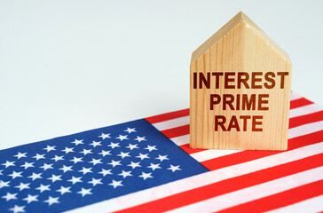 On the US flag is a model of a wooden house with the inscription - INTEREST PRIME RATE