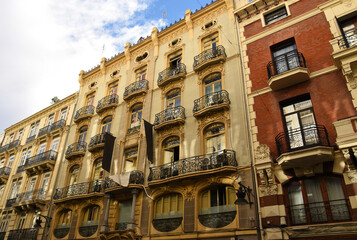 Facade building. Residential building with balconies and windows. Historical apartment house. House with window and balcony. Buildings architecture and home facade. Modern minimalistic architecture.