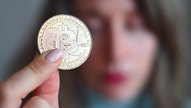 Woman holding a bitcoin crypto currency close up