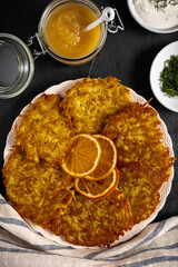 Potato pancakes or latke served with sour cream, dill, and applesauce. Garnished with dried orange slices.
.