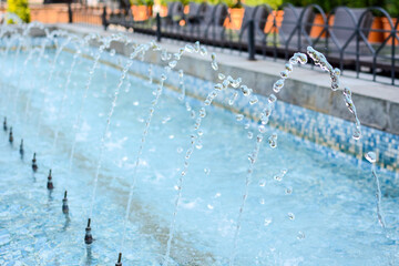 Fragment of fountain water drops in the air. Water droplet fountain