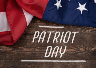 American Flags and text Patriot day on Wooden Background.