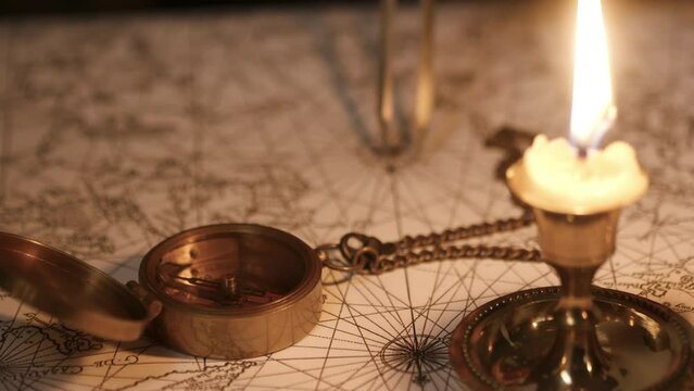 closeup of a 18th century compass and ocean map
