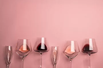 Foto op Aluminium Glasses with red, rose and white wine on pink background, with copy space © vectorfusionart