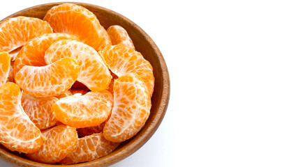 Orange segments in wooden bowl on white background.
