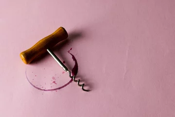 Fotobehang Red wine stain and corkscrew on pink background, with copy space © vectorfusionart