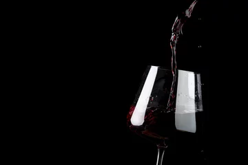 Rolgordijnen Glass of red wine on black background, with copy space © vectorfusionart