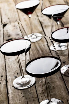Glasses with red wine on wooden background, with copy space
