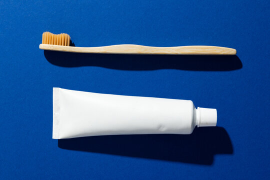 Image of eco toothbrush and toothpaste and copy space on blue background