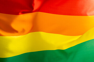 Close up of rainbow coloured flag with copy space