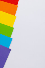 Close up of rainbow coloured cards with copy space on white background