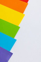 Close up of rainbow coloured cards with copy space on white background