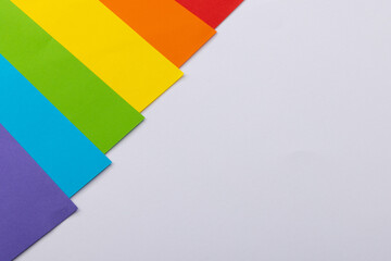 Close up of rainbow coloured cards with copy space on white background