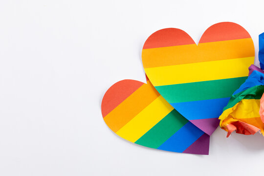 Close up of rainbow coloured hearts with copy space on white background