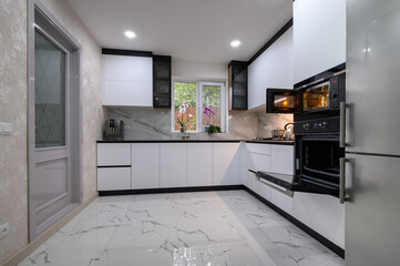 A renovated kitchen with a white, minimalist design