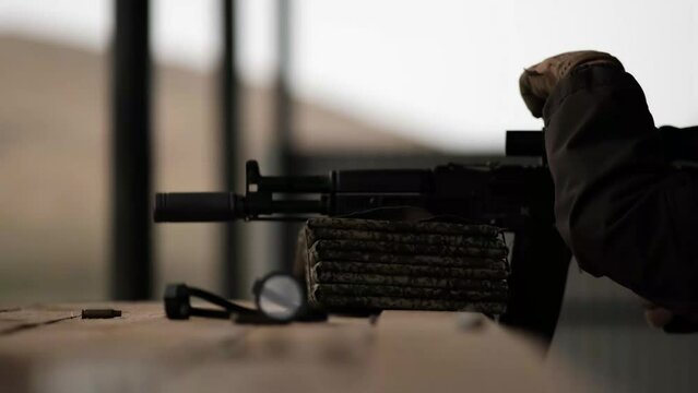 sniper shoots a rifle at war