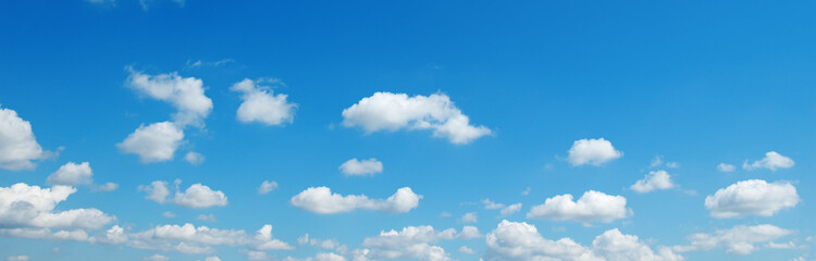 Naklejka na ściany i meble Bright blue sky with fluffy white clouds.