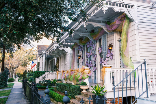 Row of Historic Shotgun Double Houses with Mardi Gras Decorations in New Orleans, Louisiana, USA - Powered by Adobe