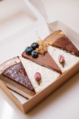 Cakes with nuts, chocolate and berries in box