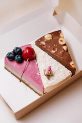 Cakes with nuts, chocolate and berries in box. Food delivery.