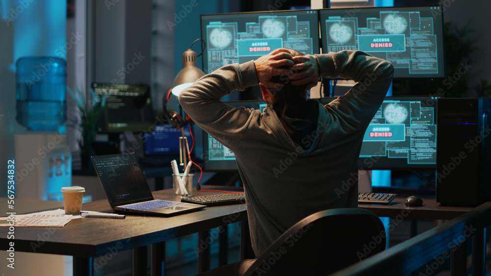 Poster frustrated hacker using computer to break into corporate data servers, working under pressure. infec