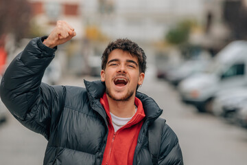 young boy in the street euphoric with joy celebrating success