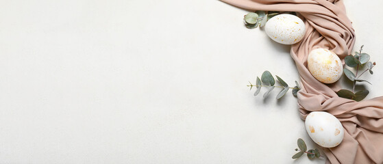 Beautiful Easter eggs, eucalyptus branches and cloth on light background with space for text - obrazy, fototapety, plakaty