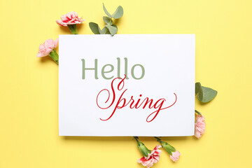 Card with text HELLO, SPRING and flowers on yellow background
