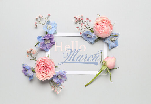 Text HELLO, MARCH and beautiful flowers on light background