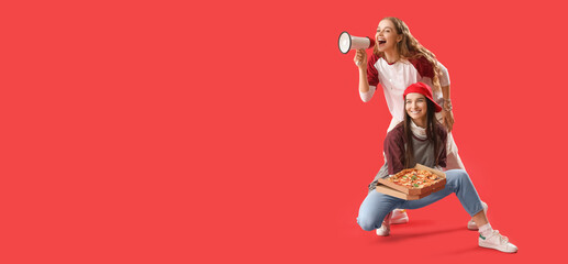 Young women with tasty pizza and megaphone on red background with space for text