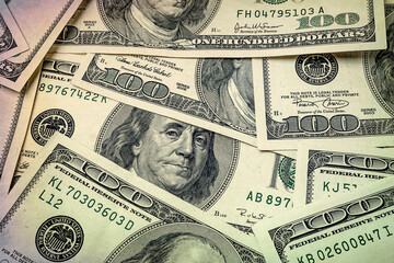 One hundred dollars. Portrait of President Franklin. US dollars background. Closeup of a lot of banknotes hundred dollar bills.  Toned image