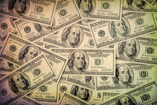 One hundred dollars. Top view money supply. US dollars banknotes background. Hundred dollar bills. American currency.  Toned image