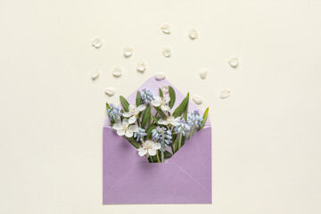 Composition with envelope and beautiful spring flowers on white background