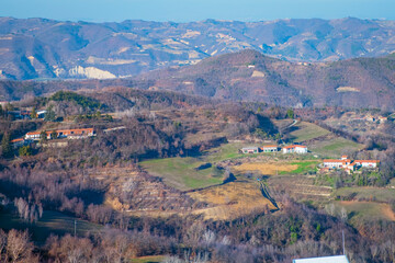 Fototapeta na wymiar Winter panorama of the hills of Langhe (Piedmont, Northern Italy); this area is world famous for valuable red and sparkling wines production and hazelnuts cultivation.