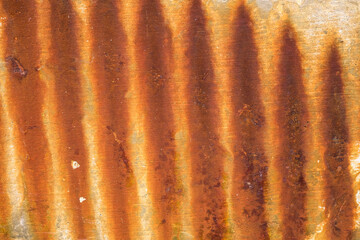 Rust from an old fence created an abstract stripe pattern on a concrete wall.