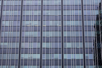 Glass and steel of a building exterior form a geometric pattern.