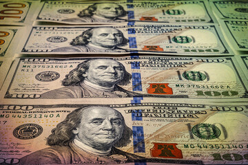 Close-up of one hundred dollars. Many banknotes. A pile of US dollars banknotes. Money background.  Toned image