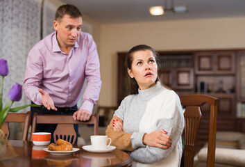 Upset man and frustrated woman arguing at home. High quality photo