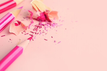 Pink pencils with shavings on color background, closeup